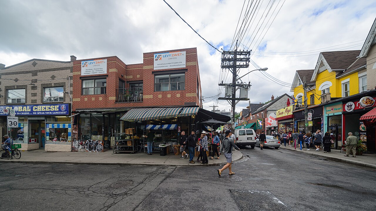 Narrow pedestrian street in Toronto with shop awnings and chalk sandwich boards